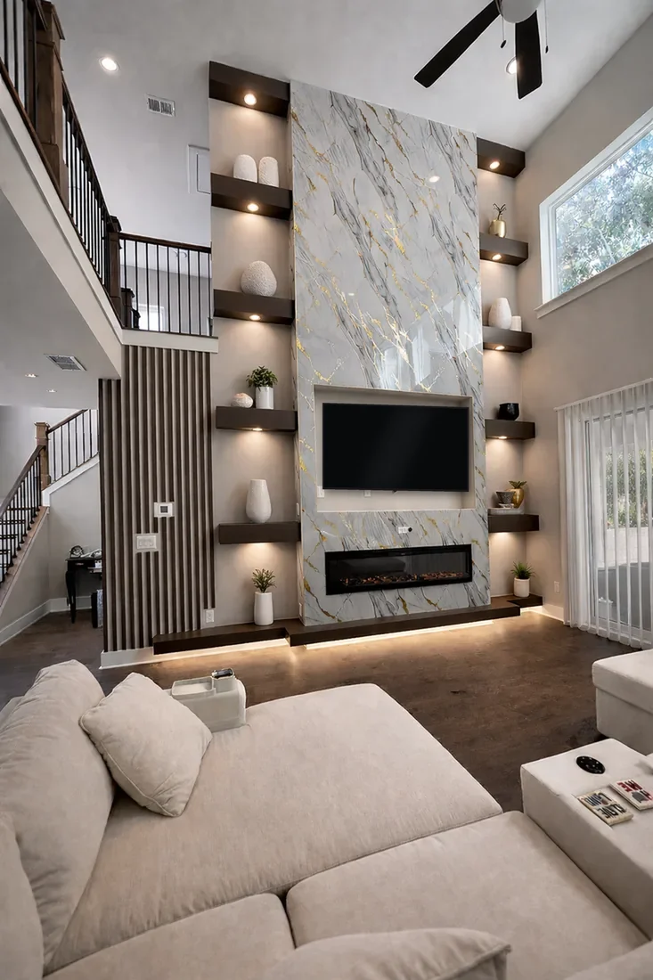 Double height marble media wall with a screen, floating shelves and a linear fire