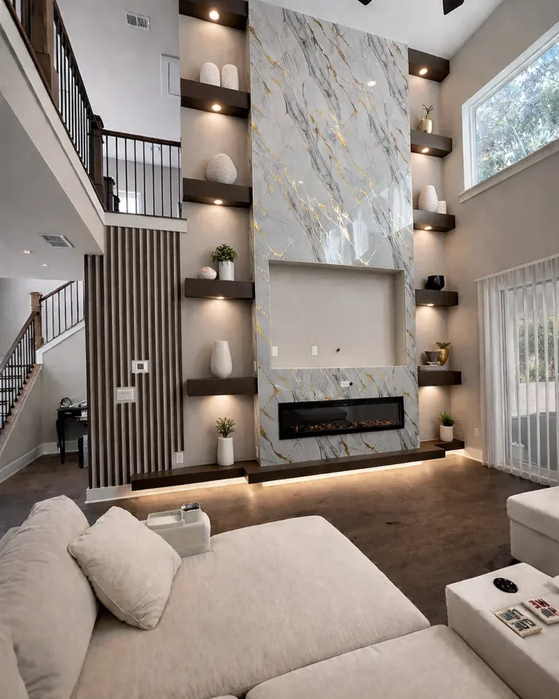 The same living room finished, with a marble media wall, floating shelves and a linear fire